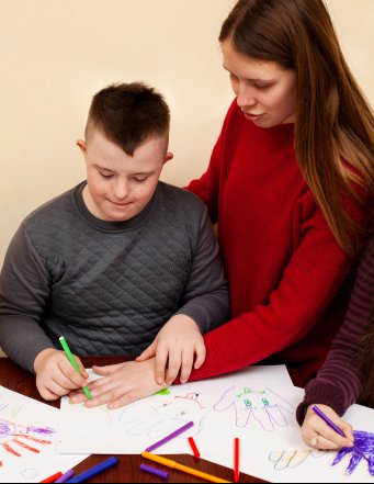 woman-helping-boy-with-down-syndrome